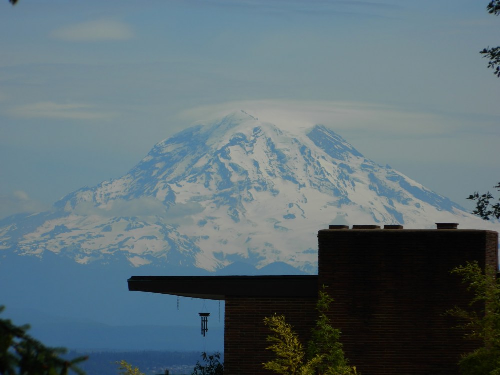 Mount Rainier looming over a house in the Stadium District in Tacoma in the summer. (Photo by Craig Craker)