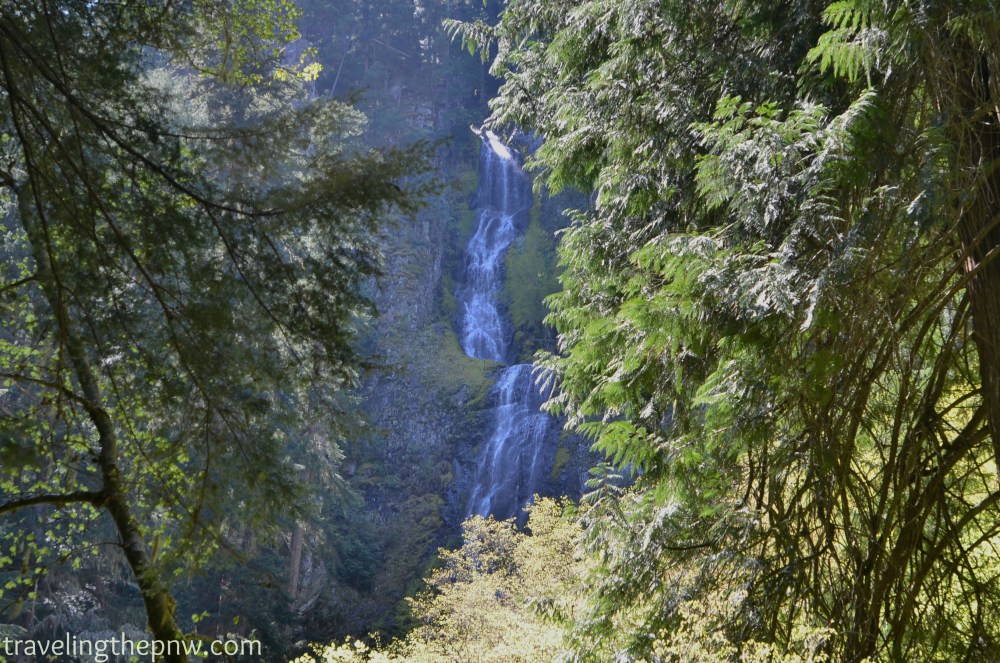 Skookum Falls is at least 200 feet tall, and has multiple cascades. This was shot from further down the trail. There is also apparently a viewpoint from the highway that affords similar views.