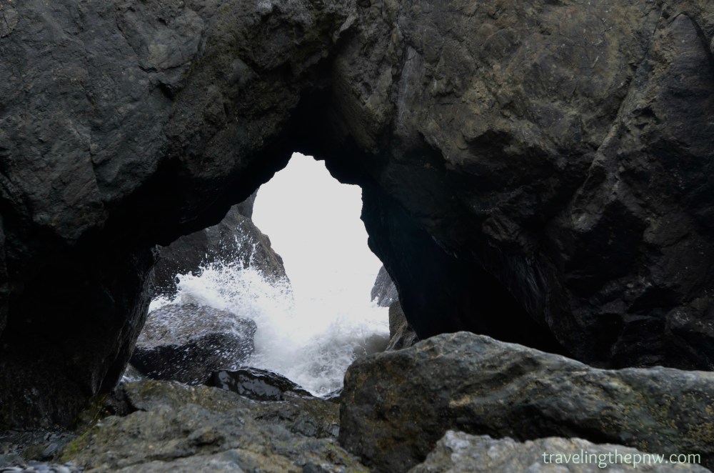 Crashing waves like this one had created a tunnel in the rocks on the shores of Ruby Beach.