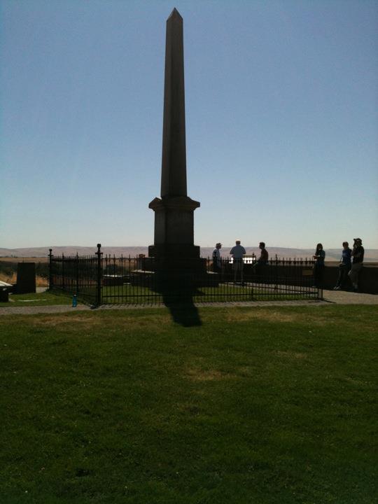 The memorial obelisk on top of a hill on the mission's property.